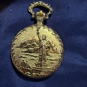 Gold Pocket Watch with Statue of Liberty Design